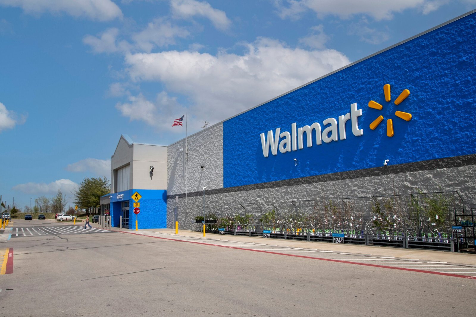 A Walmart store with the Walmart logo and gardening products on display.