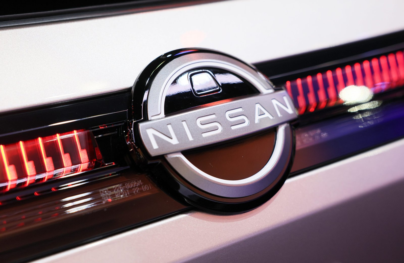 Close up of Nissan logo on car.